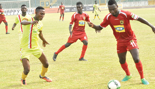 Kotoko defender Eric Donkor, (right)   takes on an opponent in their match against Techiman Eleven Wonders